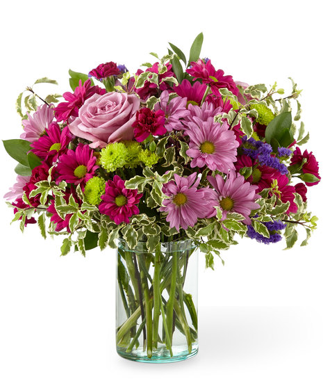 Lovely pink and mauve flowers in a cylinder vase