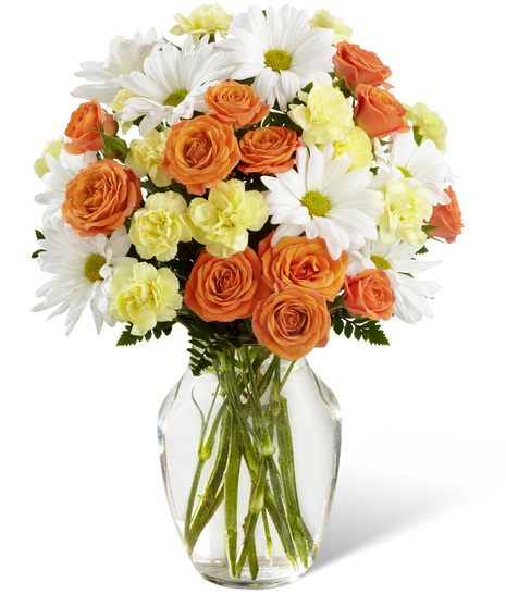 Daisies, spray roses and mini carnations in a vase