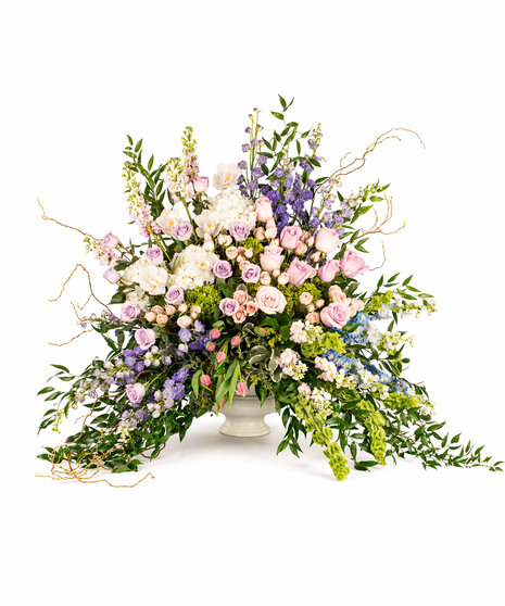 garden of remembrance tribute with pastel flowers including roses hydrangea and greenery in pedestal vase