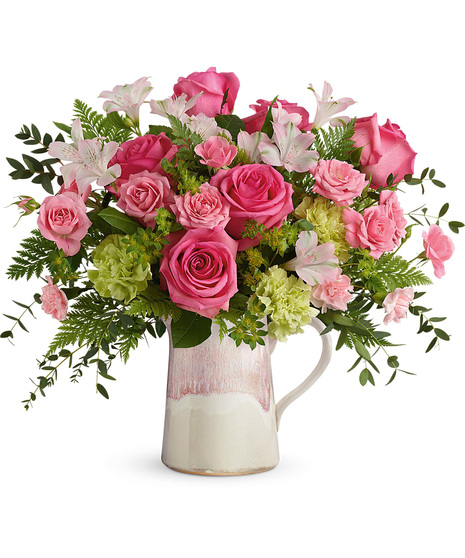 Pink flowers arranged in a stoneware pitcher