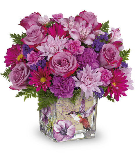 Flowers arranged in a lovely hummingbird design cube vase