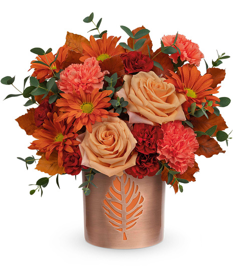 Fall flowers arranged in a candleholder vase