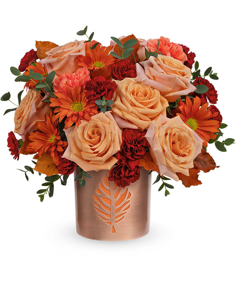Fall flowers arranged in a candleholder vase