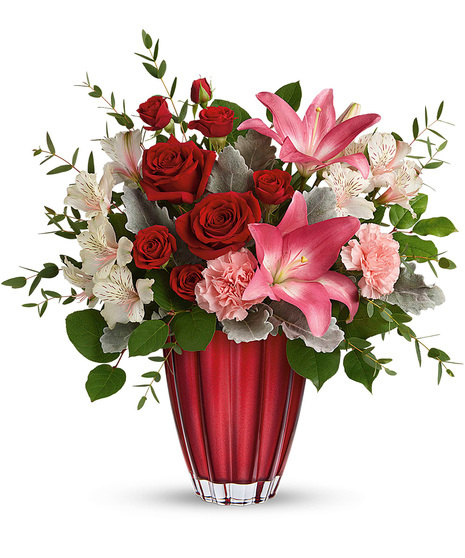 Romantic flowers arranged in a superior red vase