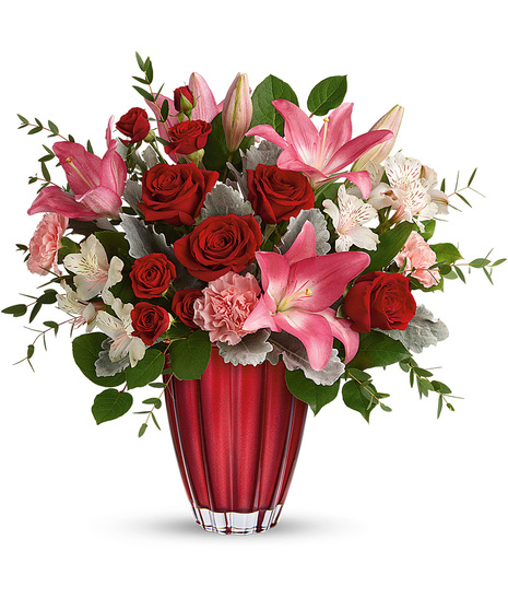 Romantic flowers arranged in a superior red vase