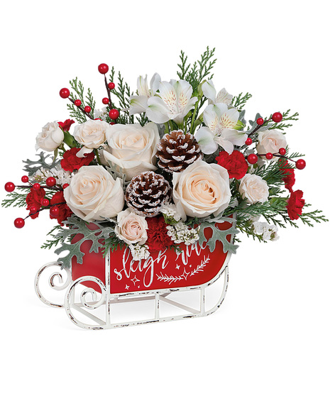 Christmas flowers arranged in a holiday sled