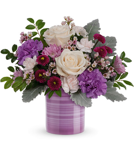Cream, pink and purple flowers in a lavender Serene Swirl Vase