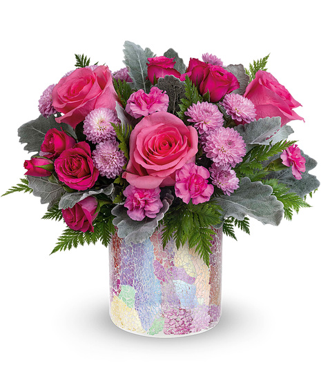 Pink and lavender flowers in a matching cylinder vase