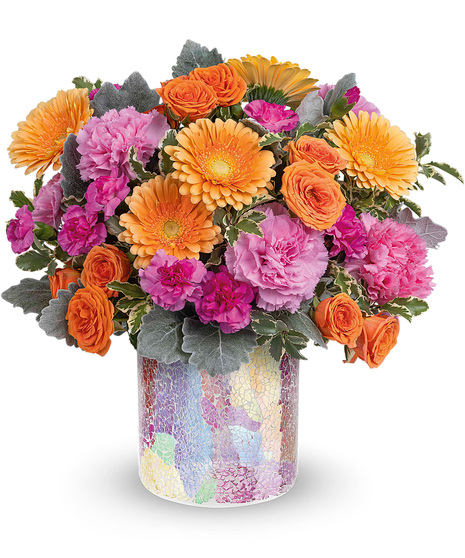 Orange, peach and pink flowers in a matching cylinder vase