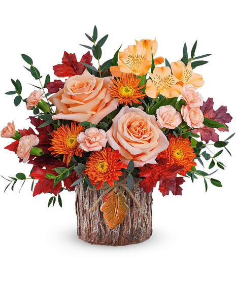 Fall bouquet in a forest themed cyclinder vase