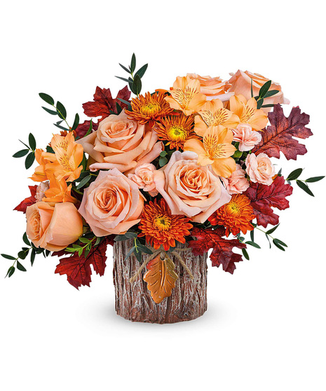 Fall bouquet in a forest themed cyclinder vase