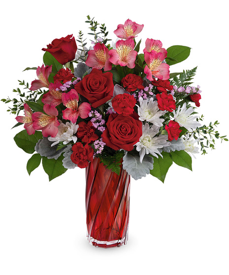 Red, pink and white flowers in a keepsake red glass vase