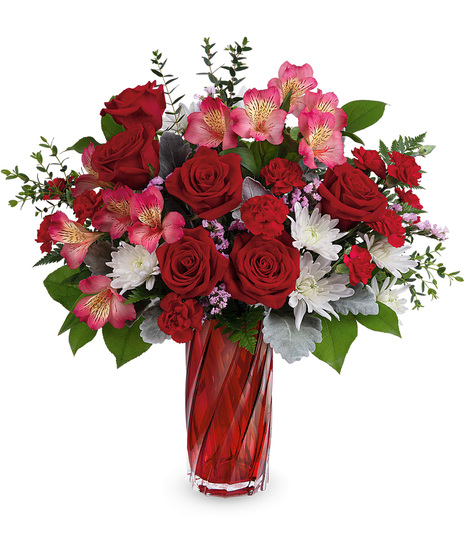 Red, pink and white flowers in a keepsake red glass vase