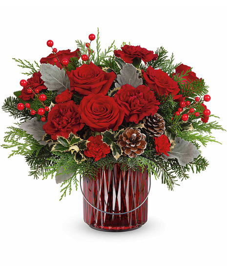 Christmas flowers designed in a vase that can be used as a candleholder afterwards.