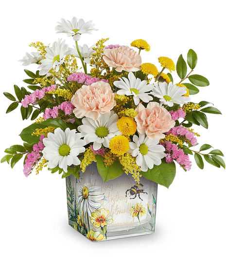 Honey Kissed Bouquet with peach carnations, yellow and white chrysanthemums, and pink statice, arranged in a vintage-inspired garden glass cube.
