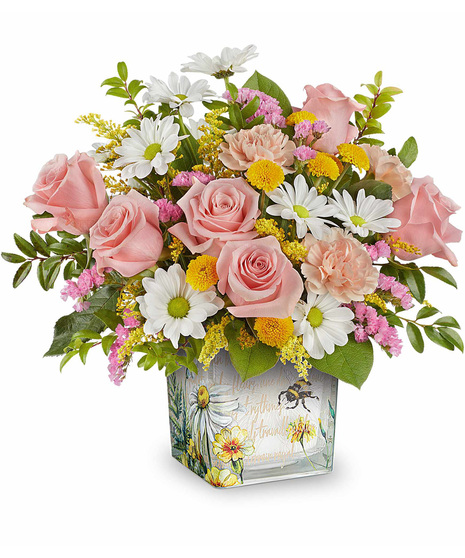 Honey Kissed Bouquet with peach carnations, yellow and white chrysanthemums, and pink statice, arranged in a vintage-inspired garden glass cube.