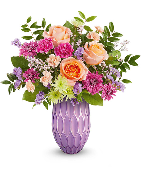 Purple, orange, pink and green mother's day arrangement in purple vase.