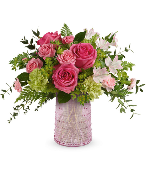 Roses, alstroemeria, and carnations in sparkling pink vase.