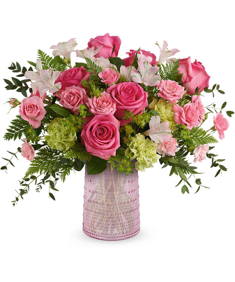 Roses, alstroemeria, and carnations in sparkling pink vase.