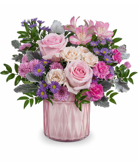 Pink purple and green mother's day arrangement in shiny pink vase.