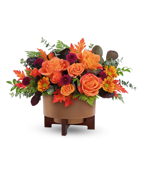 Fall for Copper Centerpiece with orange roses, spray roses, chrysanthemums, and autumn accents in a copper planter with wooden stand.