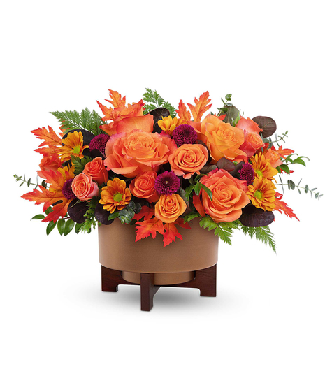 Fall for Copper Centerpiece with orange roses, spray roses, chrysanthemums, and autumn accents in a copper planter with wooden stand.