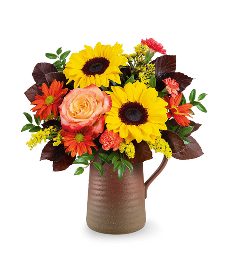 Sunburst Harmony Bouquet with sunflowers, roses, carnations, and bronze daisies in a rustic Terra Bloom Pitcher.