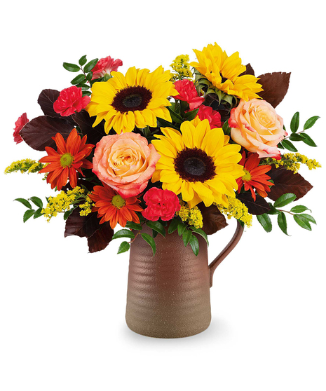 Sunburst Harmony Bouquet with sunflowers, roses, carnations, and bronze daisies in a rustic Terra Bloom Pitcher.