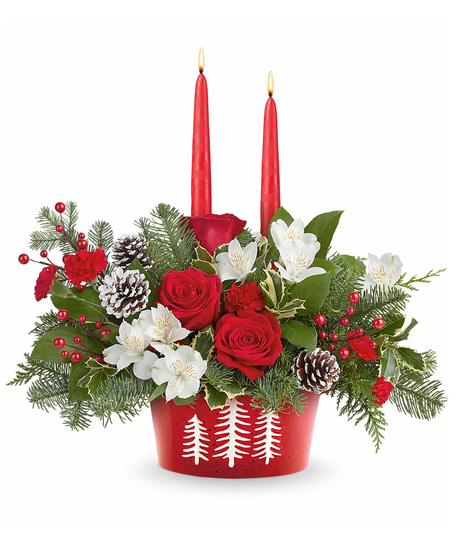 Evergreen Charm Centerpiece with red roses, white alstroemeria, red miniature carnations, evergreens, and candles in a snowy pines dish.