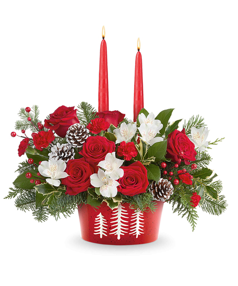 Evergreen Charm Centerpiece with red roses, white alstroemeria, red miniature carnations, evergreens, and candles in a snowy pines dish.