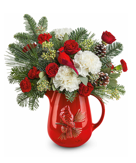 Scarlet Cardinal Bouquet with red spray roses, white carnations, and red miniature carnations accented with seeded eucalyptus and winter greens in a cardinal pitcher.