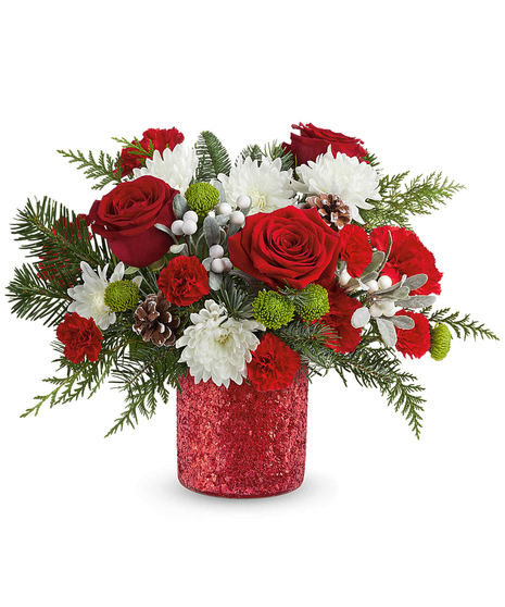 Christmas Magic Bouquet with red carnations, green button chrysanthemums, white cushion mums, evergreens, and pinecones in a glittering holiday vase.