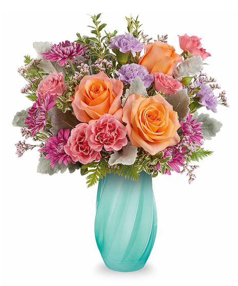 Blue Radiance Bouquet with orange roses, pink and lavender blooms arranged in a sculpted blue glass vase