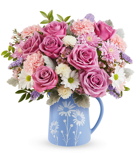 Pastel Meadow Bouquet with lavender roses and pastel flowers arranged in a blue pitcher with white daisy design