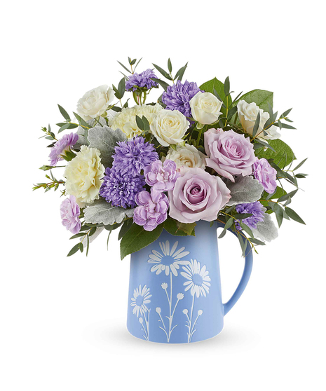 Daisy Haze Bouquet with lavender roses, pastel flowers, and greenery arranged in a blue pitcher with white daisy design