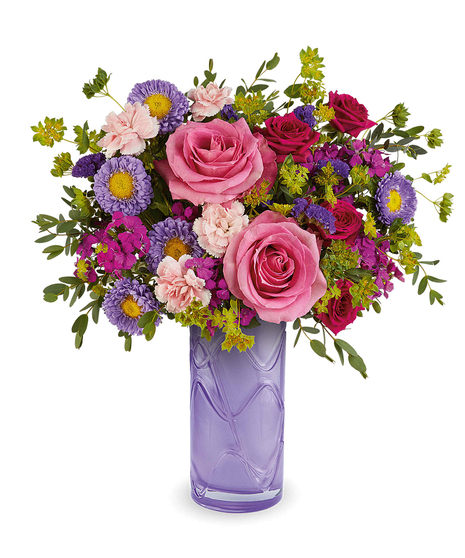 painted petals bouquet with pink roses and purple flowers in a lavender glass vase