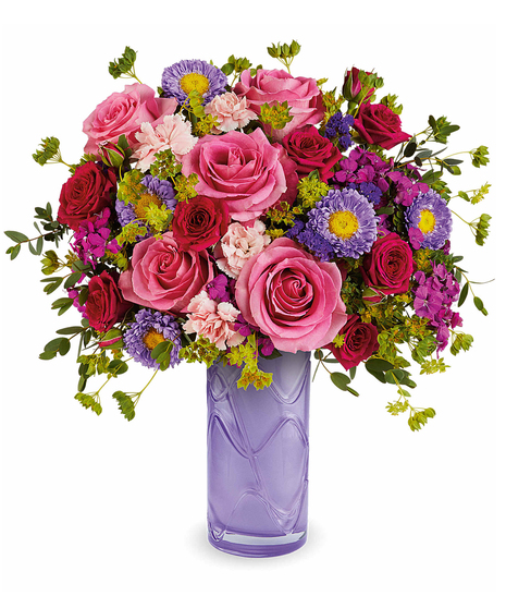 painted petals bouquet with pink roses and purple flowers in a lavender glass vase