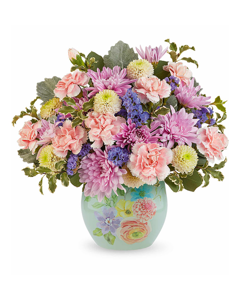 pretty in pastels bouquet with pink, peach and lavender flowers in a decorative floral glass vase