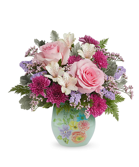 dream in bloom bouquet with pink roses and lavender flowers in a decorative floral glass vase
