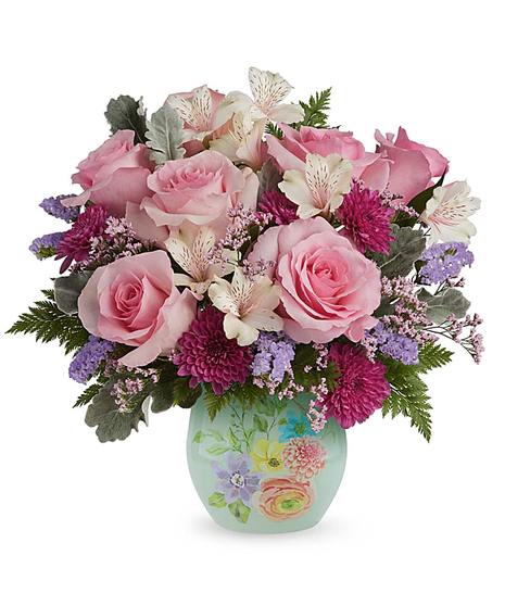 dream in bloom bouquet with pink roses and lavender flowers in a decorative floral glass vase