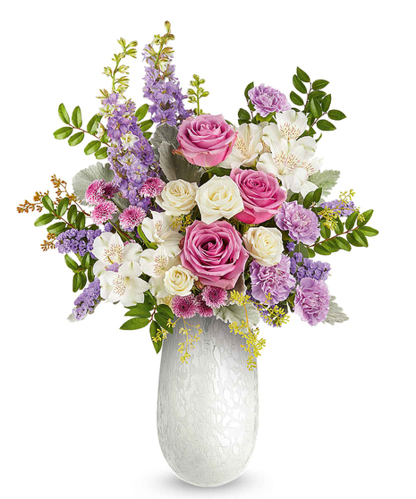 prism petals bouquet with pink, lavender and ivory flowers in a textured glass vase