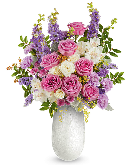 prism petals bouquet with pink, lavender and ivory flowers in a textured glass vase
