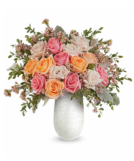 opal garden bouquet with pink and peach roses in a textured glass vase