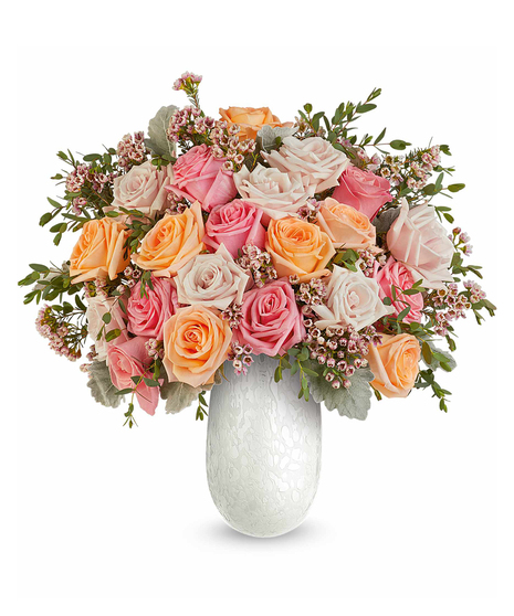 opal garden bouquet with pink and peach roses in a textured glass vase