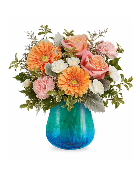 Coral and peach flower arrangement in turquoise crackled glass vase