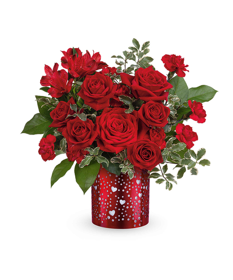 Romantic all-red flower arrangement with roses, alstroemeria, and carnations displayed in a red metal lantern with heart cutouts