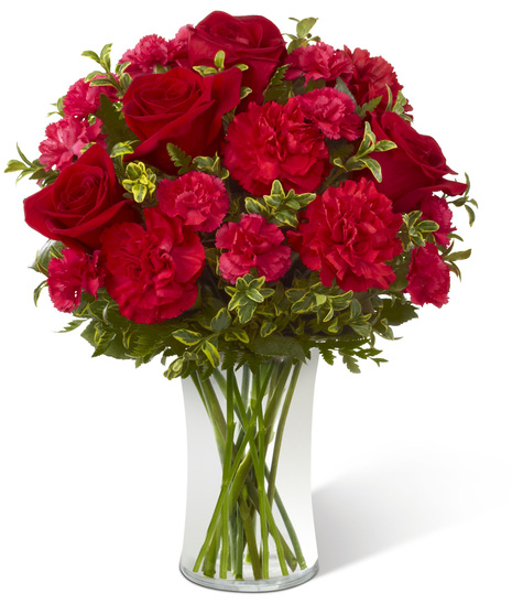 Vase of roses and carnations in red and fuchsia