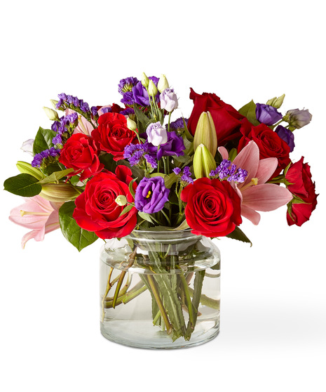 Pink, red and purple flowers in a glass vase