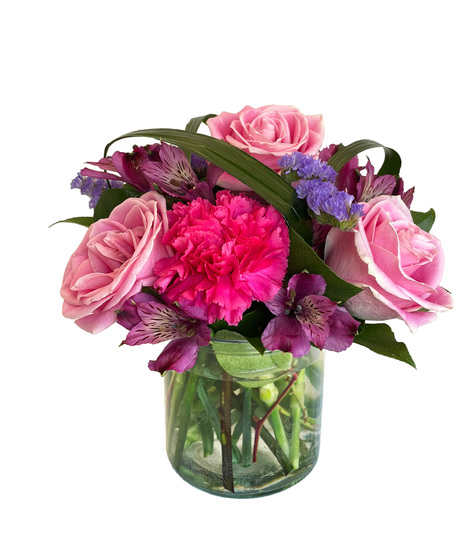 Vibrant and colourful arrangement designed in a clear cylinder vase.