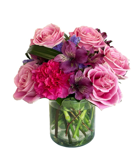 Vibrant and colourful arrangement designed in a clear cylinder vase.